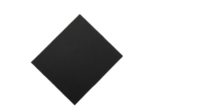 A dark gray, slightly textured, diamond-shaped object is presented against a pure black backdrop, subtly illuminated along its edges with faint multicolored specks