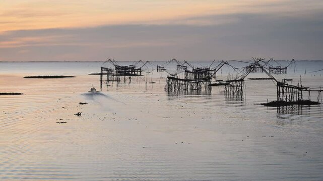 Sunrise Pakpra Lake in the morning with local travel boat in south of Thailand.