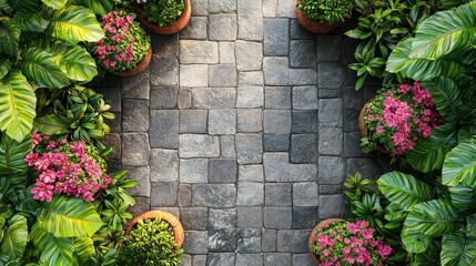 Overhead view of a paved garden path bordered by lush greenery and pink flowers
