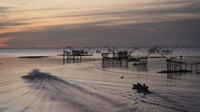 Sunrise Pakpra Lake in the morning with local travel boat in south of Thailand.