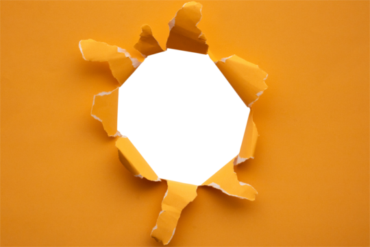 Torn ripped orange paper hole isolated on white background