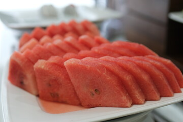 Watermelon slices plate. Fresh red juicy watermelon slices on cutting board. Summer fresh fruit snack.
