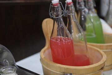 A detailed view of refreshing watermelon juice served in glass mugs with handles and straws....