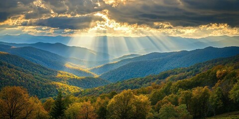 A scenic shot of sunlight filtering through the clouds over rolling hills