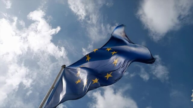 Waving blue banner with yellow star emblems set against a background of bright blue sky and white clouds, symbolizing unification.