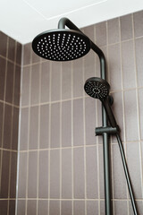 Black shower in modern apartment bathroom
