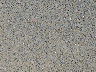 Detailed overhead shot displays rough asphalt texture, offering a versatile backdrop for design projects requiring gritty and natural surface aesthetics. Ideal for backgrounds and graphic overlays.