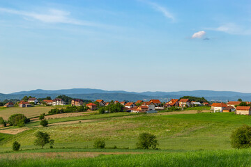 Naklejka premium Rural area in western Serbia. Fields and hills and mountains on the horizon.