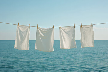 White Laundry Drying on a Clothesline by the Ocean