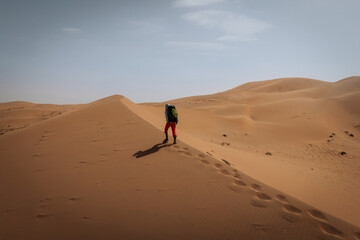 Backpacking woman hiking  in the desert