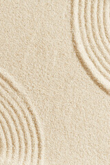 Aesthetic minimal natural sand background with sandy waves and ripples, light and shadows. Pastel colored zen garden fon for Spa, meditation, relaxation, wellness. Styled design photo, vertical