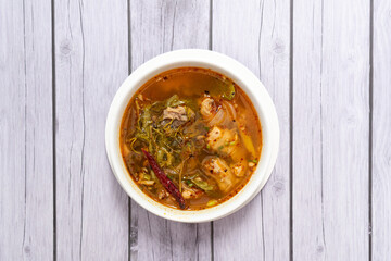 Tom Yum Chicken with young tamarind leaves, spicy and sour