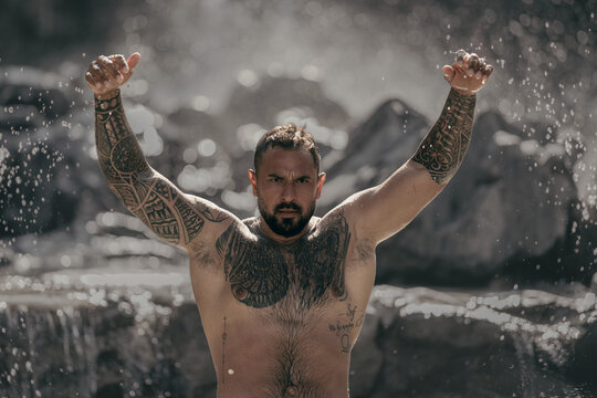 Sexy body. Healthy muscular male body under waterfall. Strong topless man splashing in nature. Fit and sexy male torso. Athletic body. Physical strength and wellness. Man beauty, body balance.
