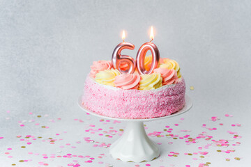 Celebrate a 60th birthday with a beautiful pink cake and candles
