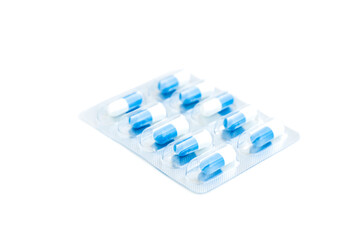 White and blue medical pills in transparent blister pack isolated on white background, Medical...