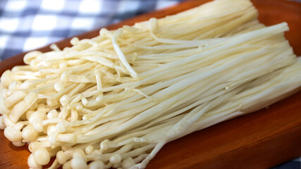 Flammulina filiformis is a species of agaric in the Physalacriaceae family. It is best known for its origin in Japanese cuisine, where it is called enokitake, and is widely cultivated in East Asia.