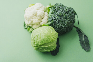 Broccoliб cabbage and cauliflower mix on green background healthy diet concept