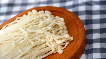 Flammulina filiformis is a species of agaric in the Physalacriaceae family. It is best known for its origin in Japanese cuisine, where it is called enokitake, and is widely cultivated in East Asia.