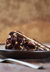 Piece of Chocolate Cake on a Plate. Rustic stone background. Copy space.	