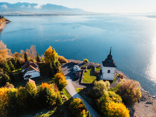 Liptov region with Tatras mountains around. Liptovska mara dam landspace. Autumn deciduous forest...