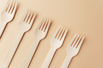 Set of wooden forks  flat lay on pastel background