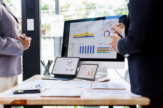 Financial Business Team analyze the graph of the company's performance to create profits and growth, Market research reports and income statistics, Financial and Accounting concept.