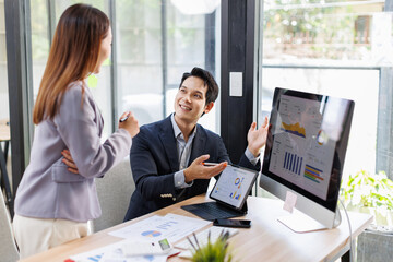 Financial analysts analyze business financial reports on a digital tablet planning investment project during a discussion at a meeting of corporate showing the results of their successful teamwork.	