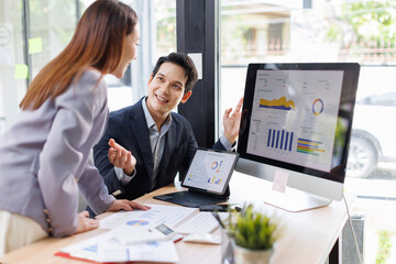 Financial analysts analyze business financial reports on a digital tablet planning investment project during a discussion at a meeting of corporate showing the results of their successful teamwork.	