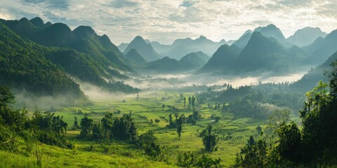A tranquil valley surrounded by mountains, with soft mist blanketing the lower slopes