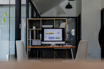 Laptop Computer, desktop computer,Analyzing department budget on computer screen, business professional working in office.business report office with a wooden desk,

