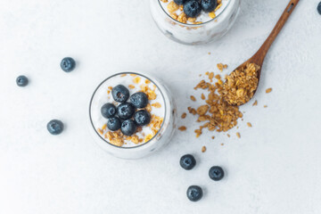 Top view of granola parfait with blueberries and yogurt