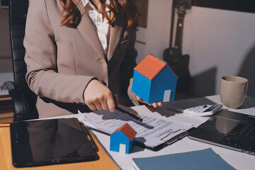 Female Real Estate Broker presenting and advised to .model home and building project detail in the...