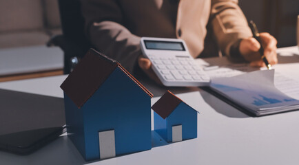 Female Real Estate Broker presenting and advised to .model home and building project detail in the...