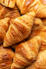 Freshly baked croissants forming an appetising background for french breakfast