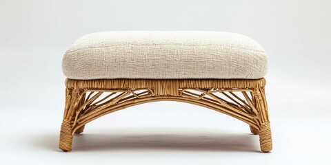 Light-colored rattan ottoman with soft fabric cushion on white background