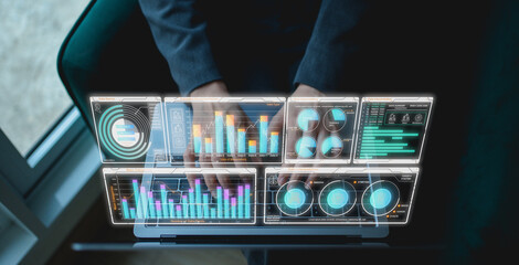 A person interacts with a futuristic digital dashboard displaying various data charts and analytics on a transparent screen.