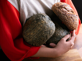 Woman hand hold fresh baked sourdough bread. Presenting Homemade ciabatta bread.