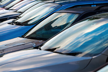 Used cars for sale parked on a parking lot of vehicle dealer