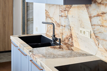 A Stylish Kitchen Featuring Elegant Marble Countertops and a Sleek Modern Faucet Design