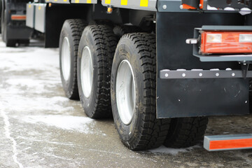 Heavy-Duty Truck Wheels on Snowy Asphalt Pavement - Transportation and Logistics Concept