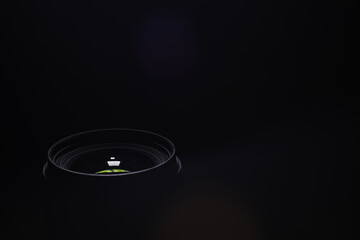 Close-Up of Camera Lens Against Dark Background with Subtle Light Reflection