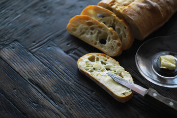 Freshly Sliced Artisan Bread with Butter on a Rustic Wooden Table