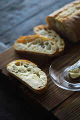 Close-Up of Artisan Bread Slices with Butter on Wooden Board