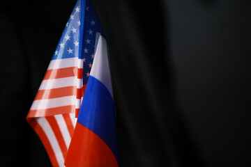 Close-Up of American and Russian Flags against Dark Background