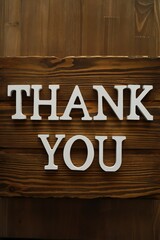 Sleek Wooden Background with Bold White THANK YOU Letters for Gratitude and Appreciation