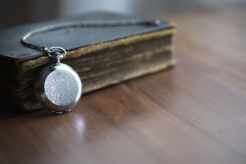 Vintage Pocket Watch and Antique Book on Wooden Table - Time, History, and Nostalgia