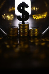 Stack of Gold Coins with Dollar Symbol Under Glass Dome