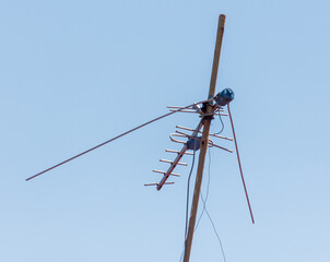 A tall antenna is on a pole