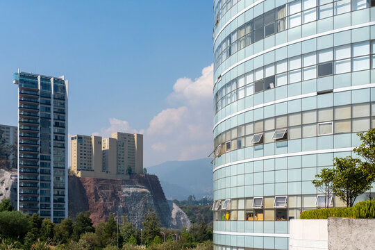 Modern architecture in Santa Fe, Mexico City with curved glass facade and high-rise buildings, showcasing innovation, business, and corporate development themes.