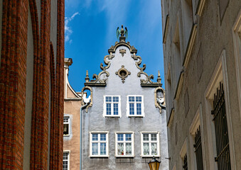 Bronze medieval eagle figurine on the roof. Ancient architecture of Gdansk	